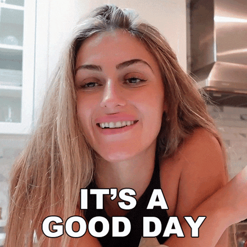 a woman smiles with the words it 's a good day behind her