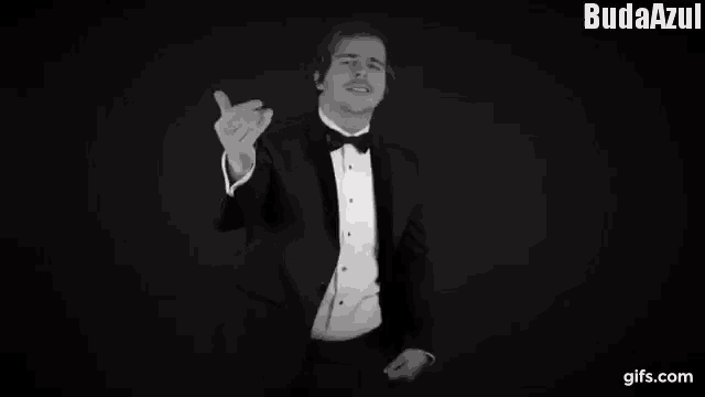 a man in a tuxedo is dancing in a black and white photo with the words budaazul at the top