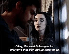 a man and a woman are standing next to each other and the woman is talking about the world changing for everyone that day