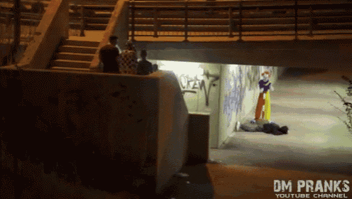 a clown is laying on the ground under a bridge with the words dm pranks youtube channel