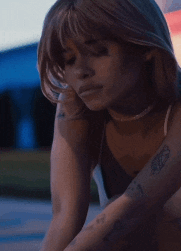 a woman with a tattoo on her arm that says ' i love you ' on it