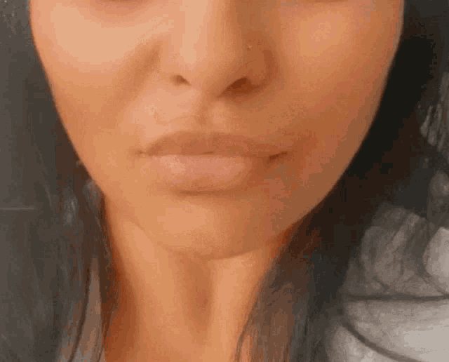 a close up of a woman 's face with her mouth open .