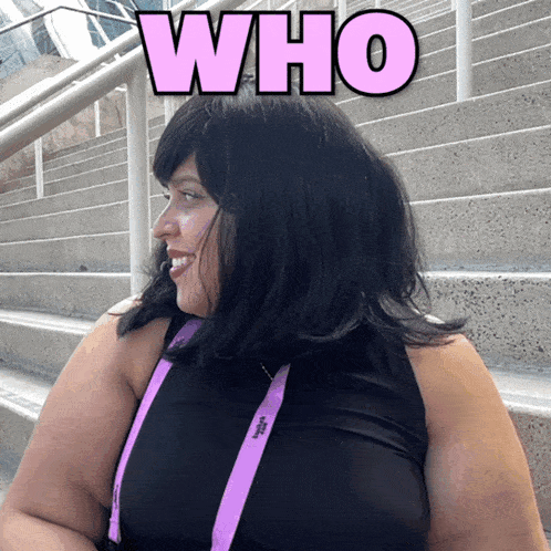 a woman wearing a black top and a purple lanyard with the word who above her head
