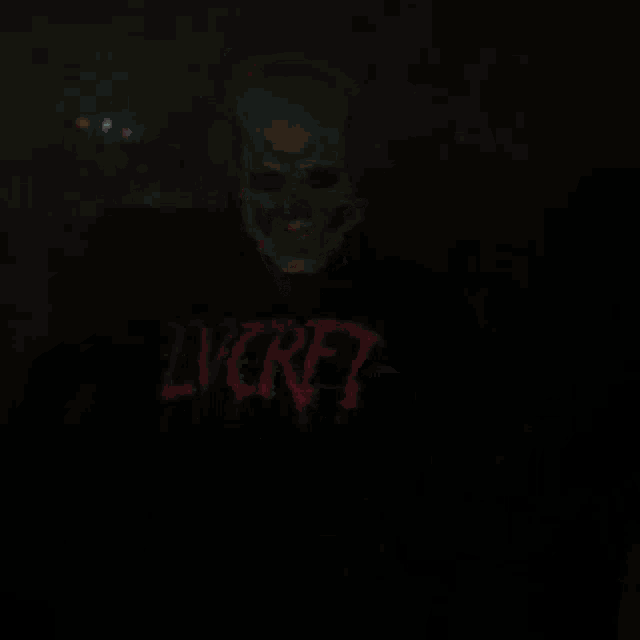 a person wearing a skull mask and headphones is wearing a shirt that says ' nirvana '