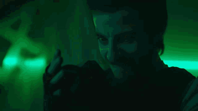 a man is smiling while holding a candle in his hand