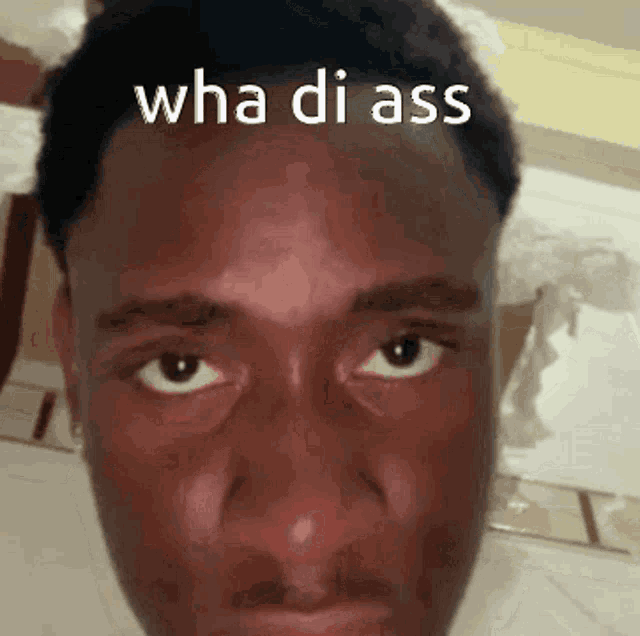 a close up of a man 's face with the words wha di ass on it