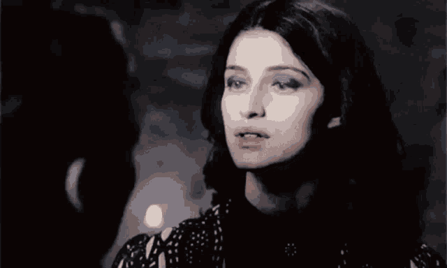a woman with blue eyes is looking at a man