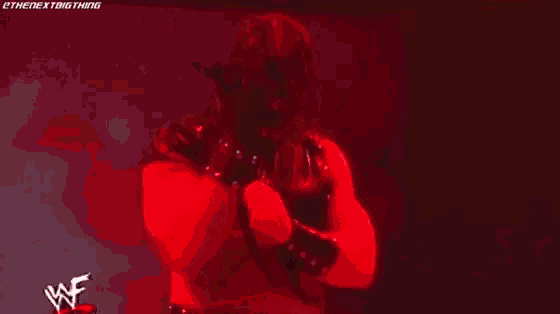 a man in a wrestling ring with a flame coming out of it and the word wrestle on the bottom