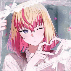 a girl with blonde hair and pink hair making a heart shape with her hands