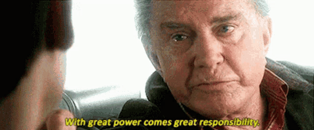 an older man is talking to a younger man and the man is saying `` with great power comes great responsibility '' .