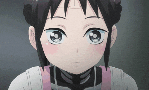 a close up of a girl 's face with a pink apron on