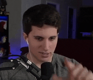 a man is talking into a microphone while wearing headphones .
