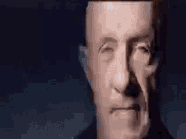 a close up of a man 's face with his eyes closed and his head visible .
