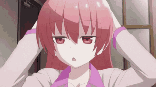 a girl with pink hair and red eyes is holding her hands to her head