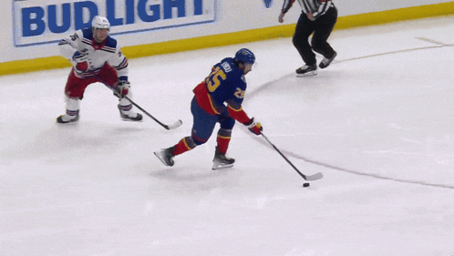 a hockey player with the number 25 on his jersey stands on the ice