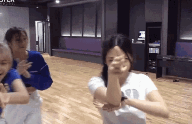a group of girls are dancing in a room with a sign that says ster recording