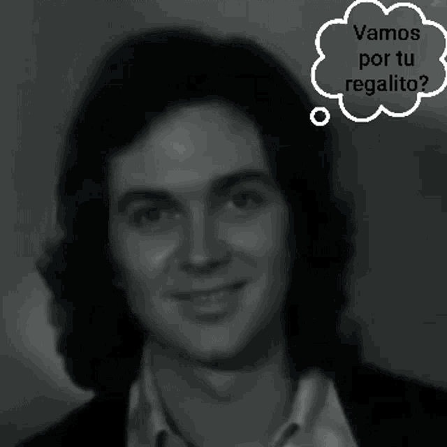 a black and white photo of a man with a thought bubble saying vamos por tu regalito