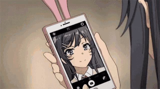 a person is taking a picture of a girl with bunny ears on a cell phone .