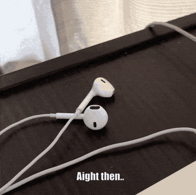 a pair of ear buds on a table with the words aight then written below them