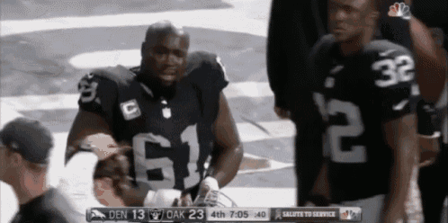 a football player with the number 62 on his jersey stands next to another player