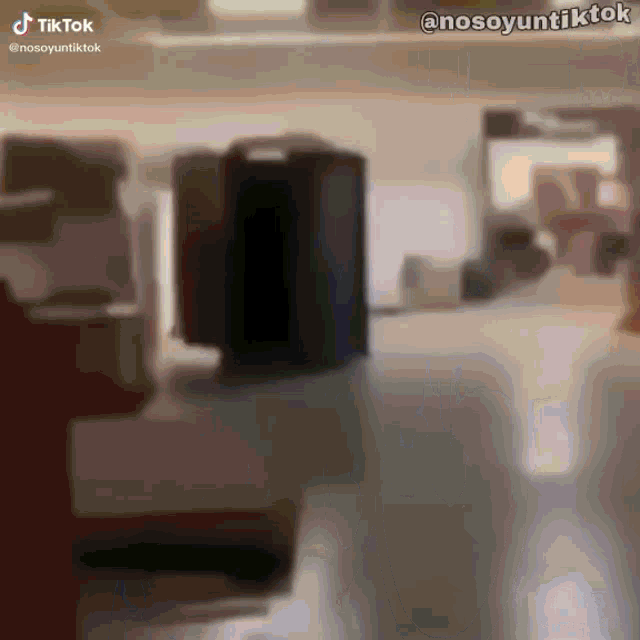 a blurred image of a room with a black box in the middle of it .