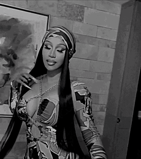 a black and white photo of a woman wearing a scarf around her head