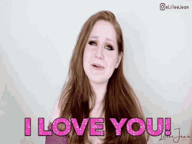 a woman is crying and says i love you in pink glitter