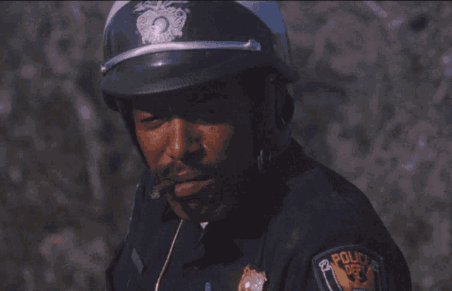 a police officer smoking a cigar and wearing a patch that says police department