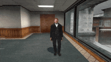 a man in a tuxedo stands in a hallway