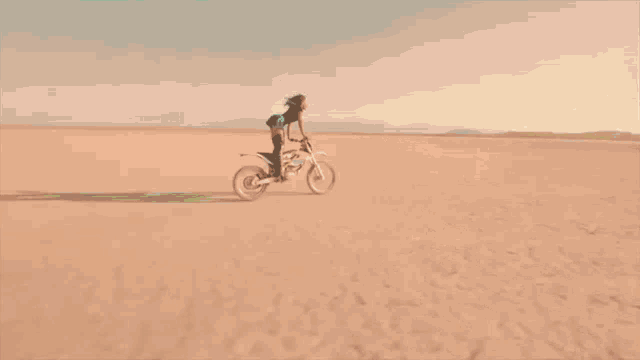 a man is riding a motorcycle in the desert .