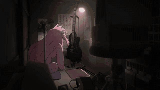 a guitar is sitting on a stand in a dark room with a poster on the wall that says ' rock '