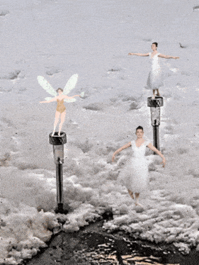 a woman in a white dress is standing on a pole in the water