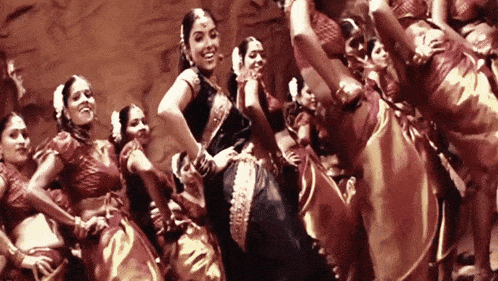 a group of women are dancing together in a circle