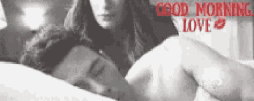 a black and white photo of a man and woman laying in bed with the words good morning love written on the bottom