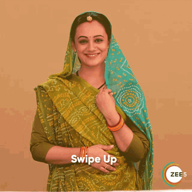 a woman wearing a green and blue dress with the words swipe up on the bottom right