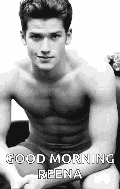 a shirtless man in underwear is sitting on a couch and says good morning reena .