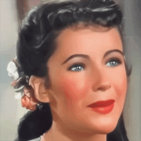 a woman with a flower in her hair is smiling