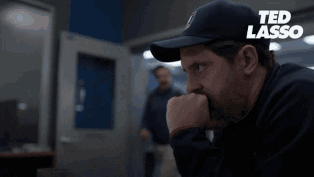 a man in a baseball cap says good morning honeybunch in front of another man