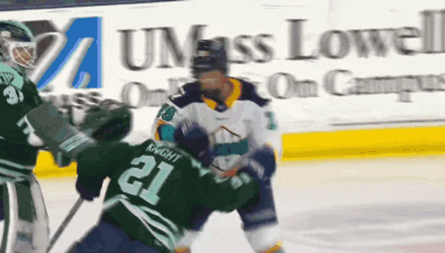 a hockey player with the number 21 on his jersey is fighting another player