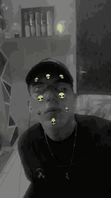 a black and white photo of a young man with aliens on his face