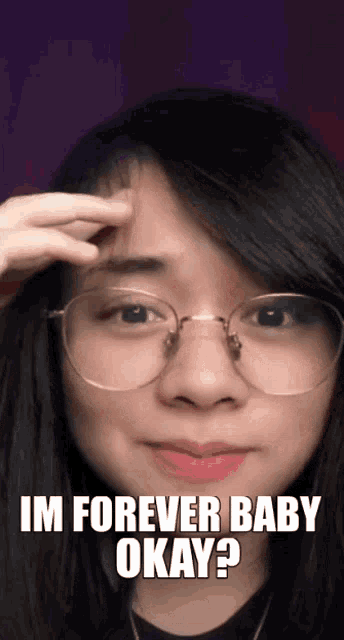 a woman wearing glasses is touching her forehead and says `` im forever baby okay ? ''