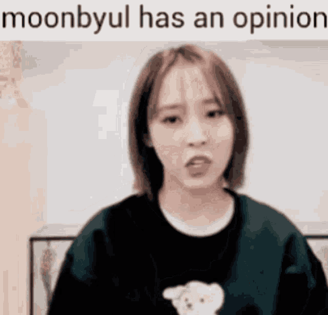 a woman wearing a black sweater with a teddy bear on it is talking .