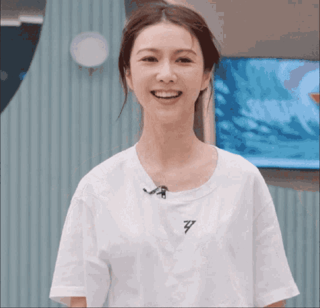a woman wearing a white t-shirt with the letter z on the front