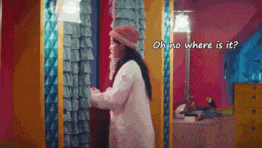 a woman standing in front of a mirror with the words oh no where is it written above her