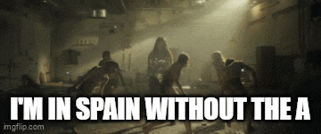 a group of people dancing in a dark room with the words i 'm in spain without the a