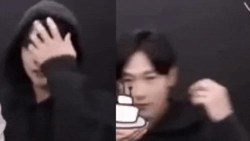 a man in a hoodie is covering his face with his hand and another man is making a funny face .