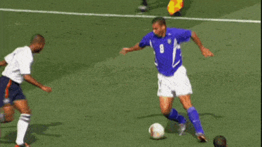 a soccer player with the number 3 on his jersey is being tackled by another player