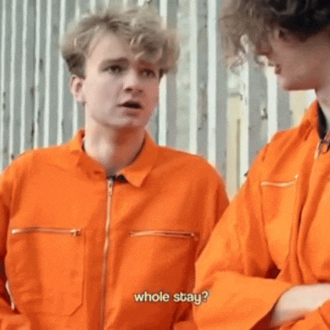 two men in orange jumpsuits are standing next to each other and one of them is asking the other to stay .
