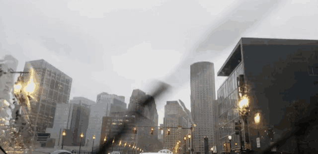 a view of a city from a car windshield with a taxi in the foreground