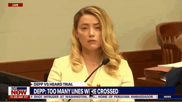 a woman sitting in front of a microphone with the words depp vs heard trial